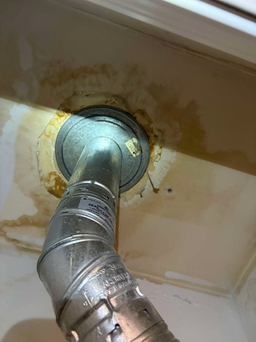 Water staining on a ceiling around a metal duct penetration