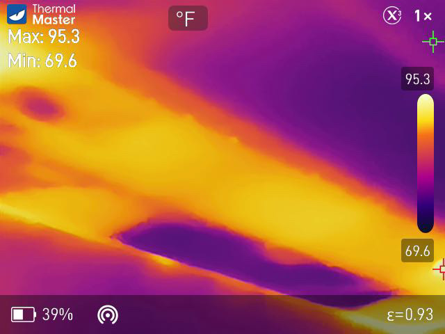 Thermal imaging scan showing hot streaks where attic insulation is missing above a ceiling